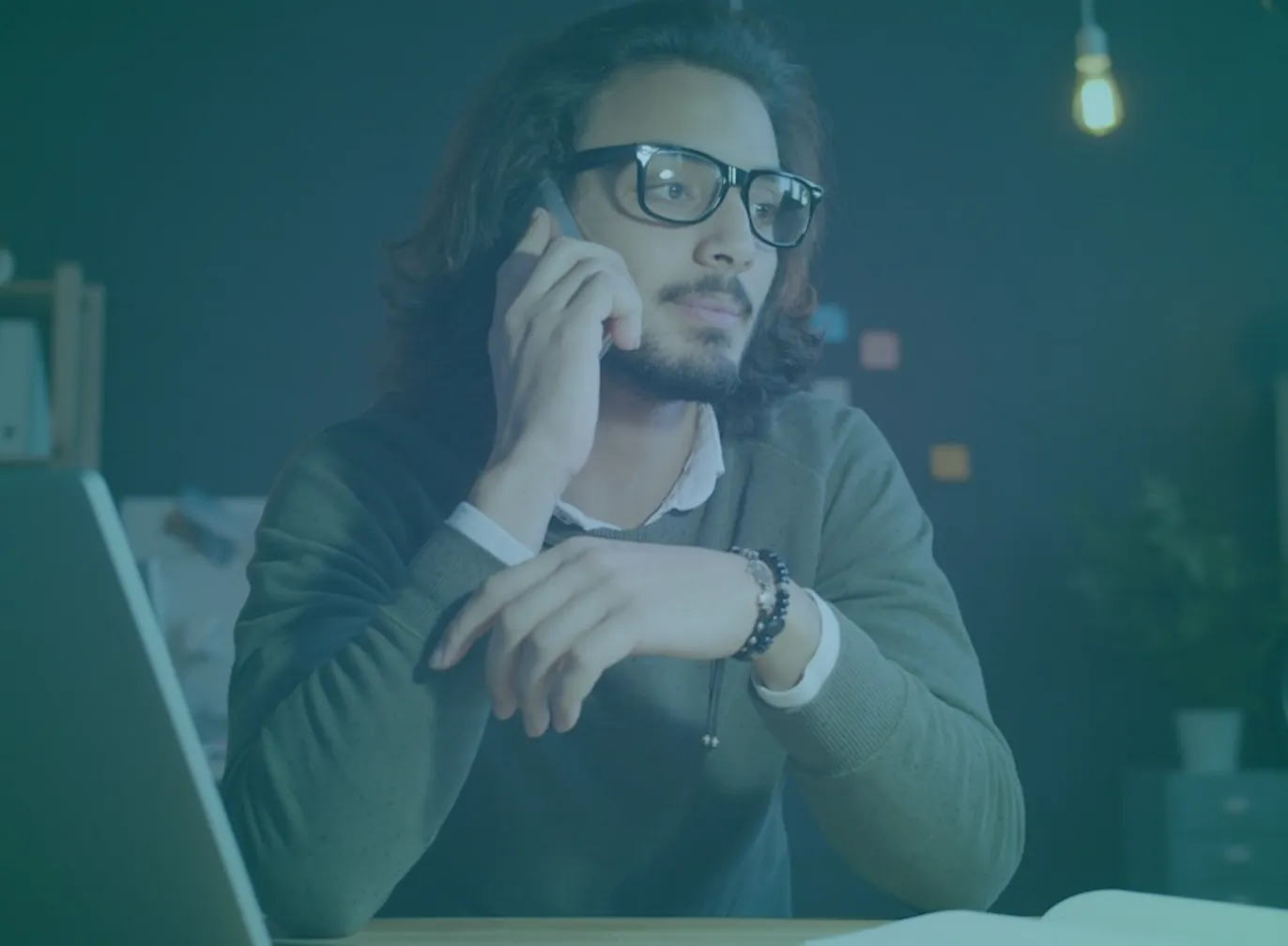 b2b-buying-committee-featured Sales leader on a phone call at a desk, representing a conversation with a member of a customer buying committee